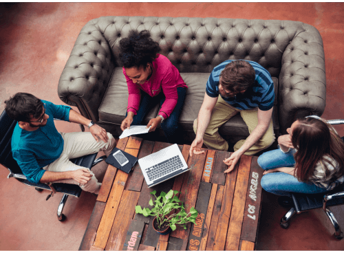 employees sitting around a coffee table c